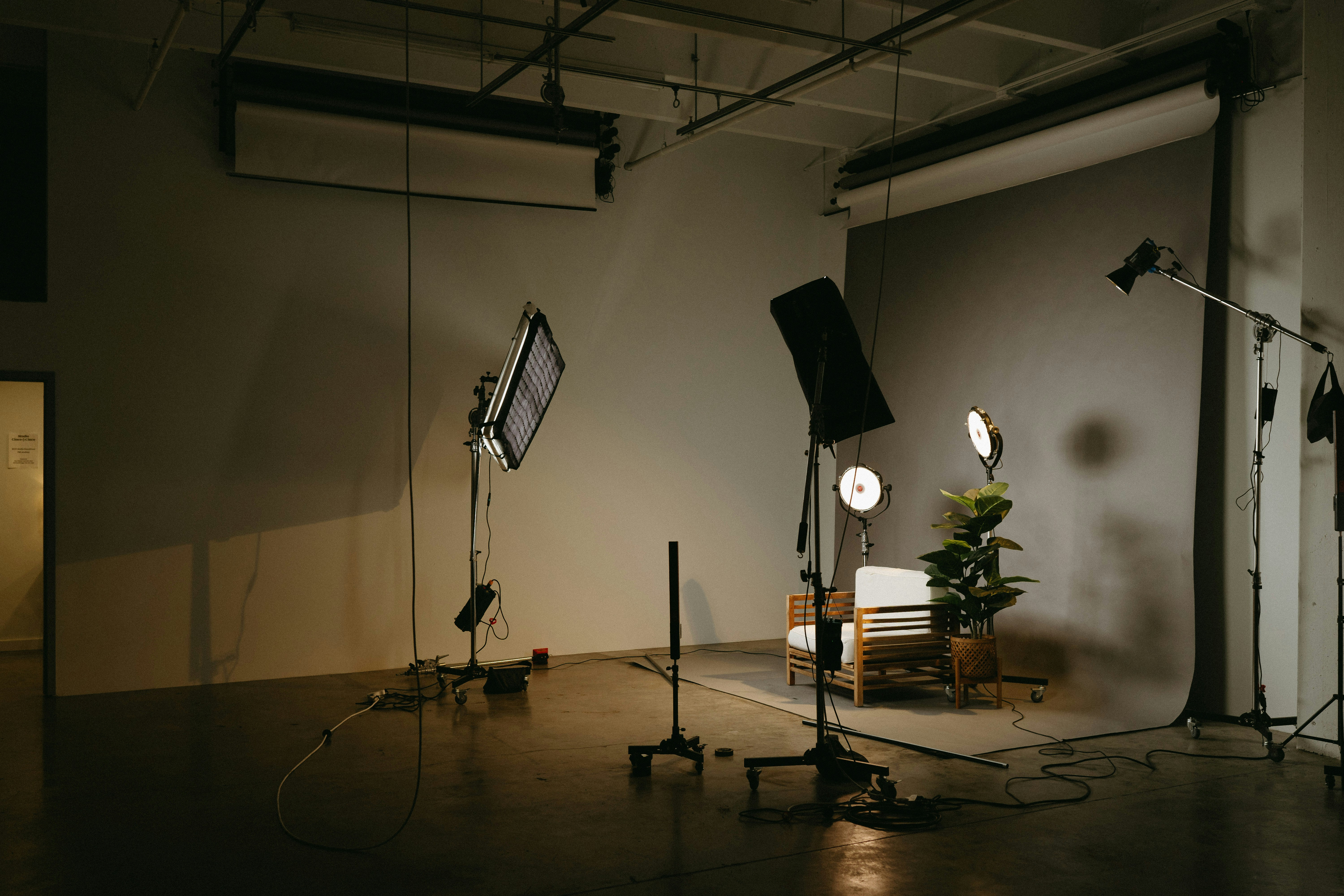 Studio lights, cameras, and equipment used for a fashion product photoshoot.