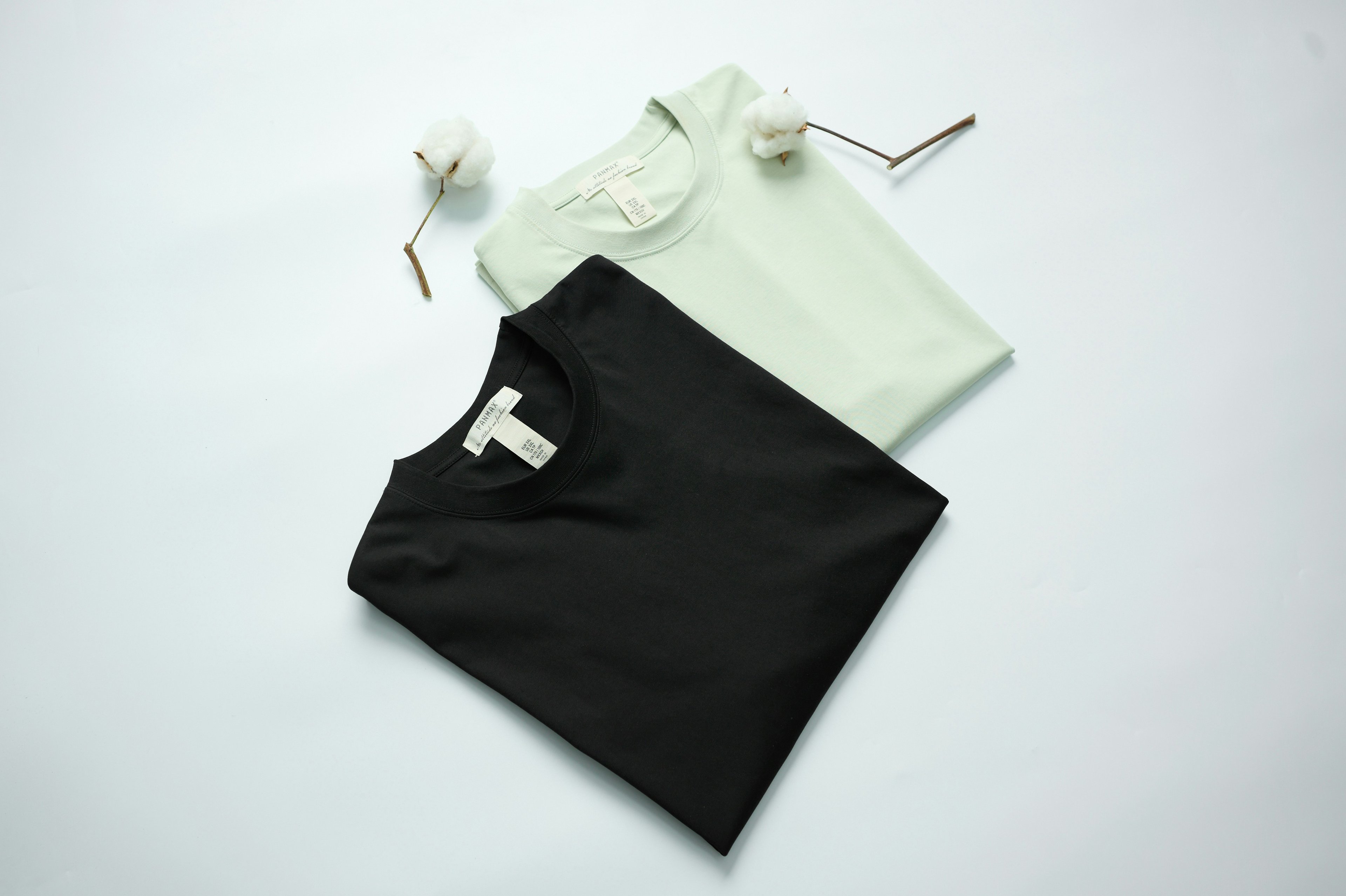 Folded organic cotton T-shirts in a clean, minimal setup.