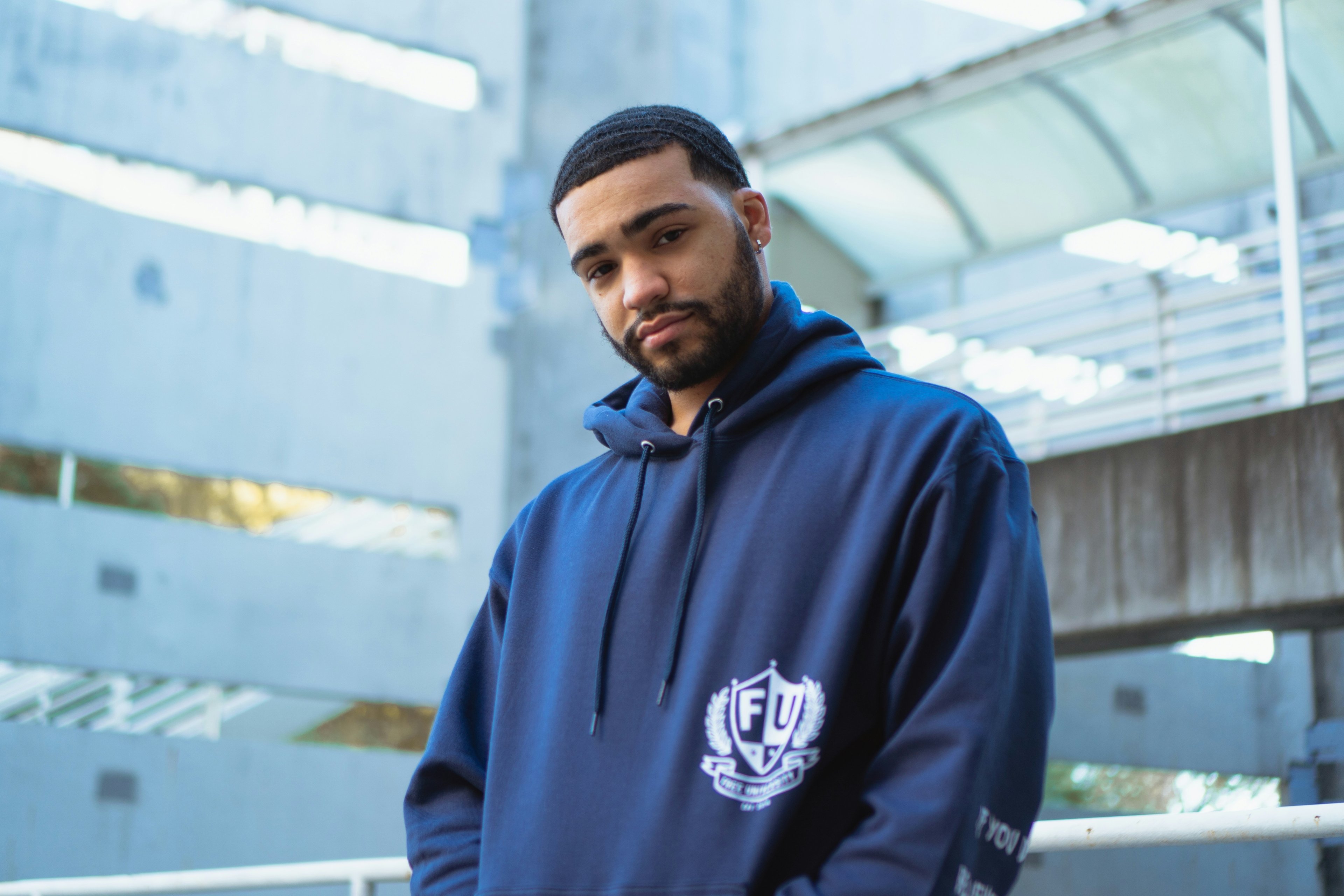 man wearing navy hoodie in modern streetwear style