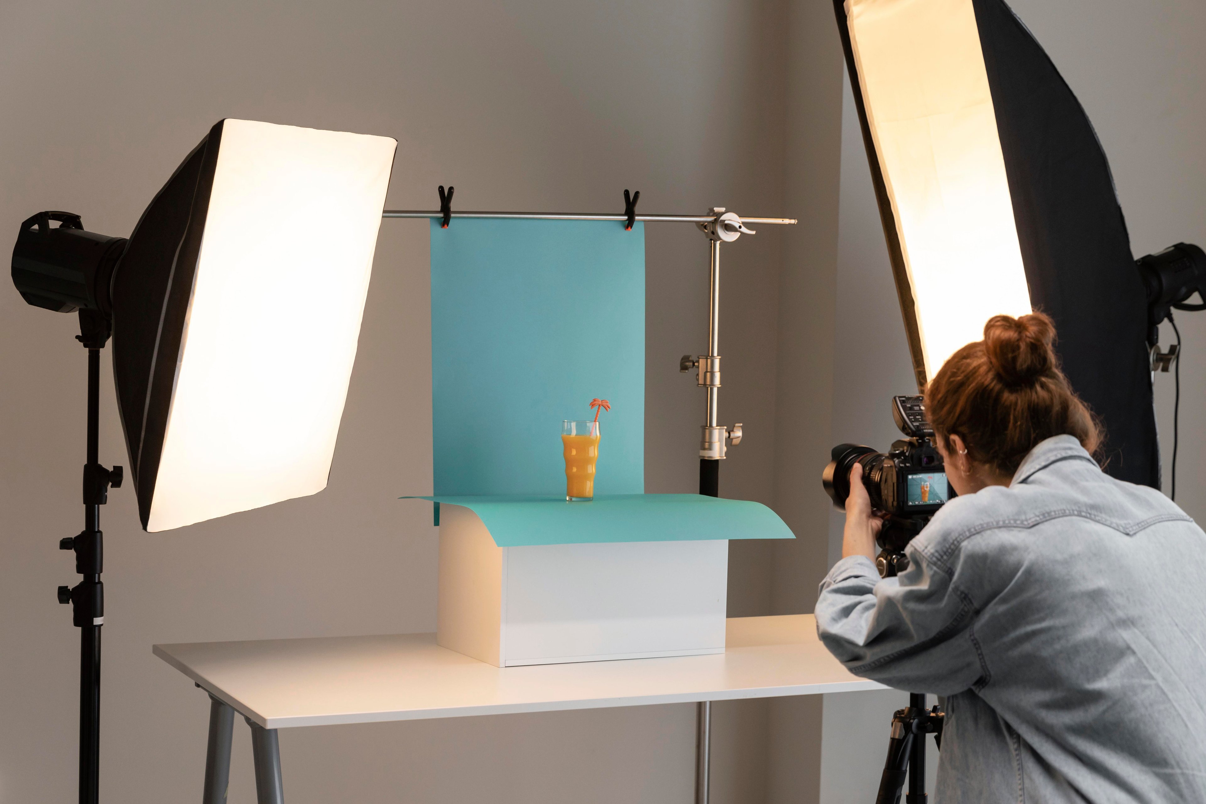 A photographer shooting a product with studio lights for a clean, professional look.