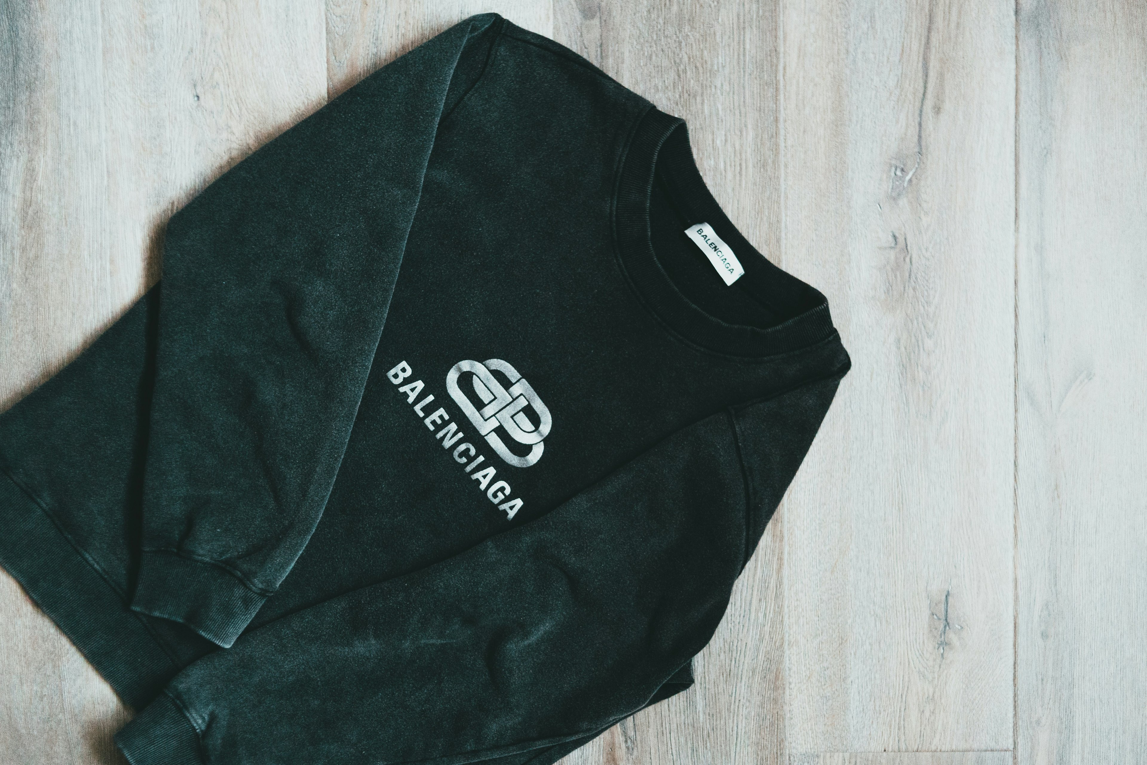 Black hoodie with logo representing clothing brand identity