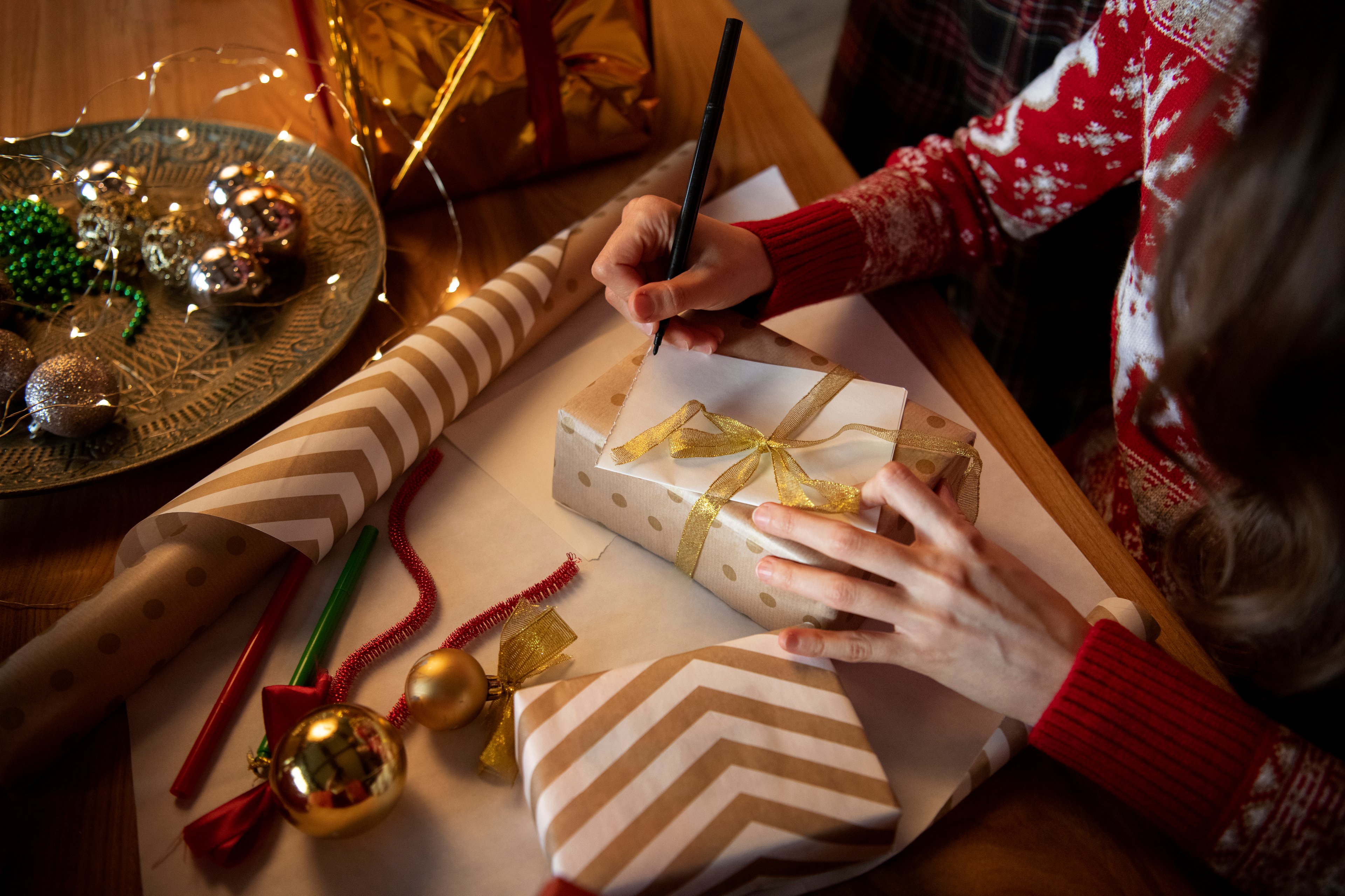 Wrapping Christmas gifts in a warm, cozy setting