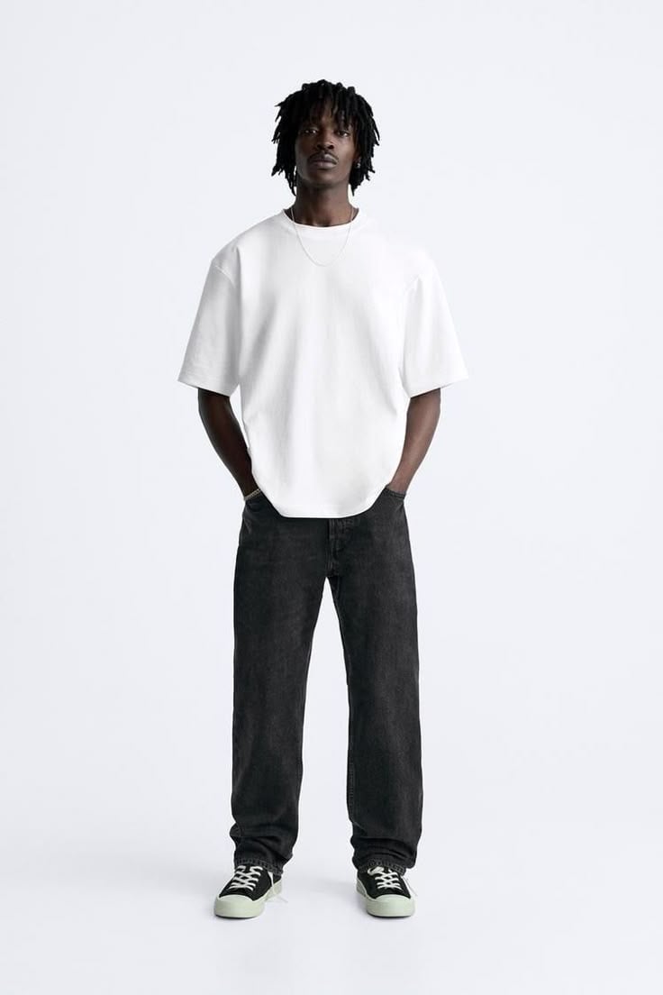 Full-length model in denim and tee on seamless off-white