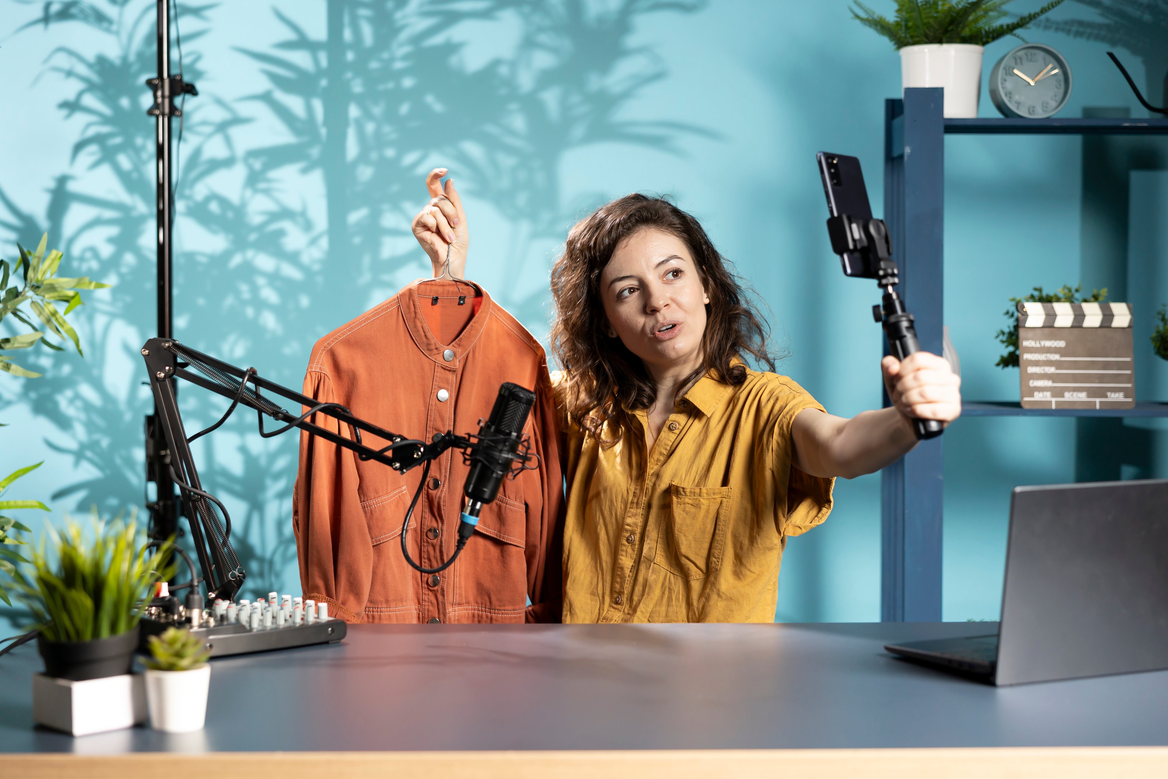 Fashion influencer filming product content with her phone.