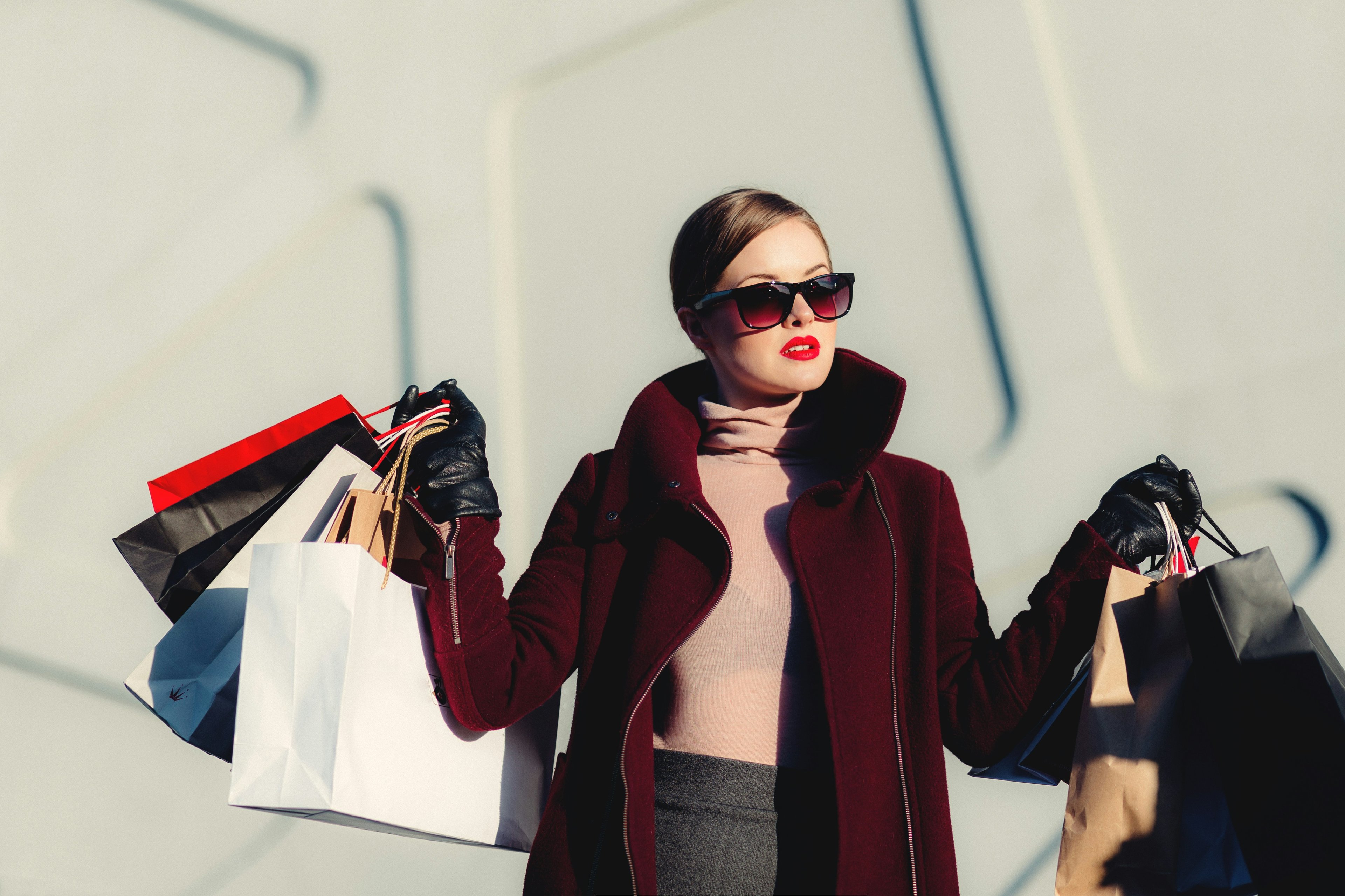 A woman holding several shopping bags after Black Friday deals