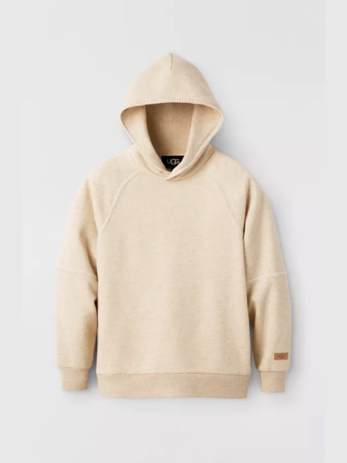 Cream UGG hoodie with raglan sleeves and a leather brand patch on the cuff, displayed flat on a light grey background.