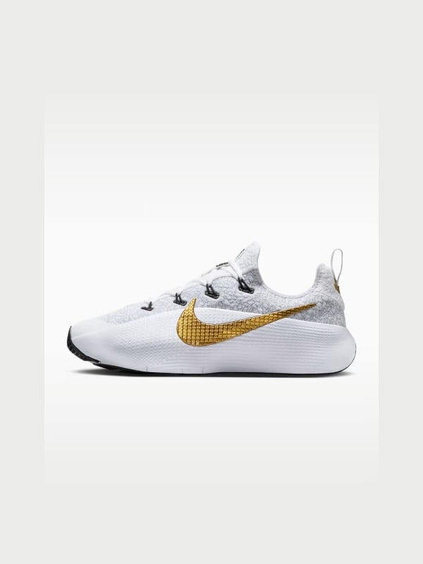 White Nike running shoe with metallic gold swoosh, shown in side profile on a light grey background.
