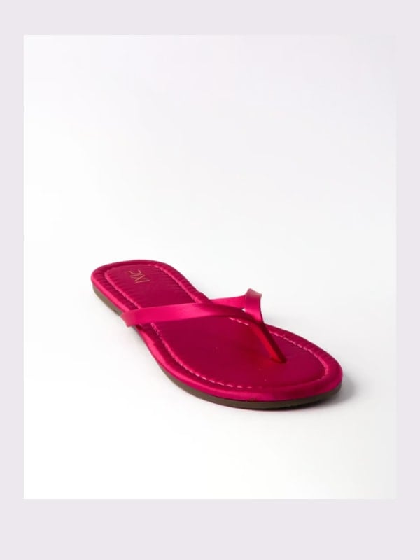 Pink satin flip-flop sandal with thin straps, shown in three-quarter view on a white background.