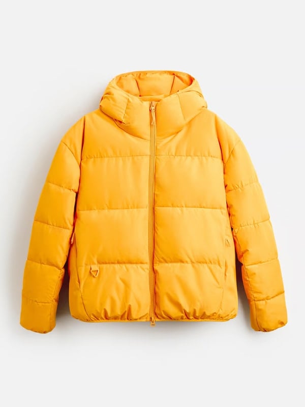 Flat lay of a bright yellow puffer jacket with a front zipper and hood, displayed on a white background.