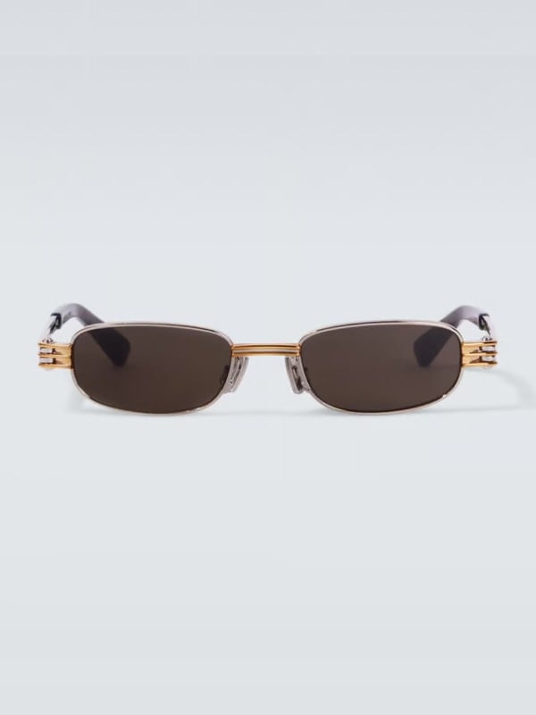 Front view of rectangular sunglasses with dark lenses, gold bridge, and black arms, displayed on a light background.