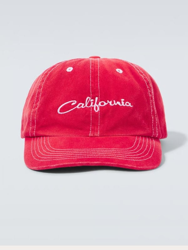 Front view of a red baseball cap with white ‘California’ embroidery and contrast stitching, displayed on a light background.