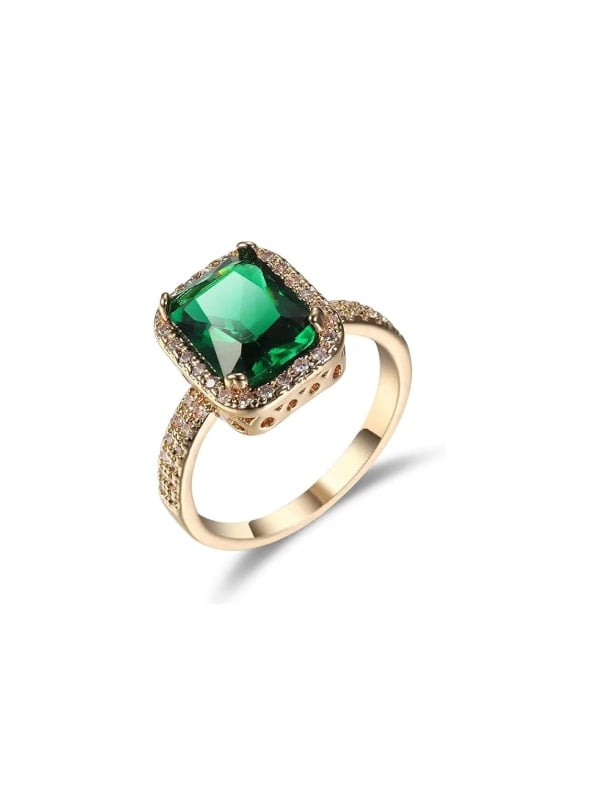 Gold ring featuring a cushion-cut green gemstone surrounded by a halo of small diamonds, with additional pavé detailing along the band.