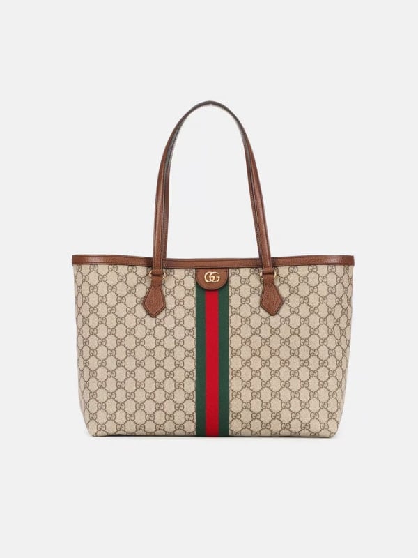 Front view of a Gucci tote bag featuring the GG monogram canvas, green-red web stripe, and brown leather trim with top handles.