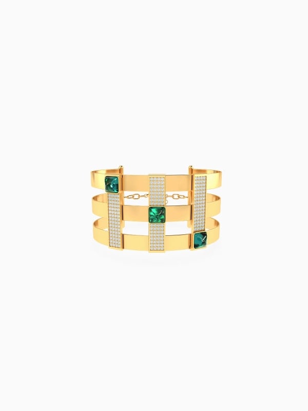 Wide gold cuff bracelet with three rows of pavé crystals and emerald green square stones, shown front-facing on a white background.