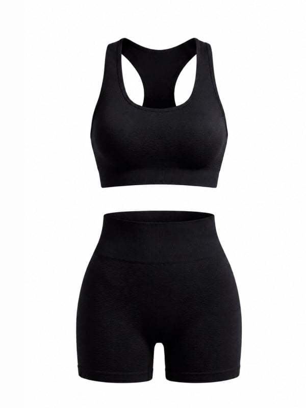 Black ribbed racerback sports bra and matching high-waisted bike shorts set, laid flat on a white background.