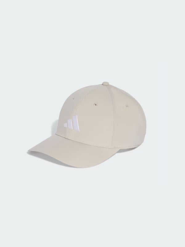 Beige Adidas baseball cap with a white three-stripe logo on the front panel, shown in three-quarter view on a light grey background.