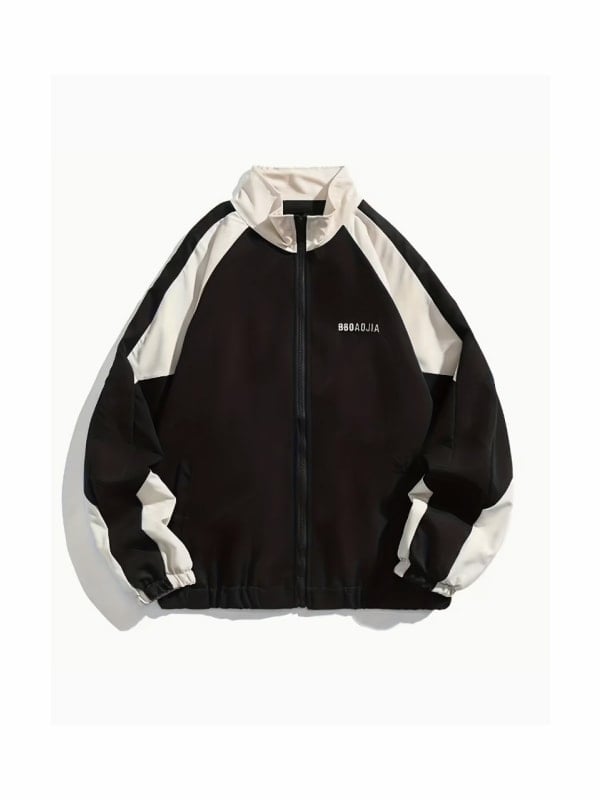 Black and cream colour-blocked retro track jacket with a stand collar and small chest text logo, displayed flat on a light grey background.