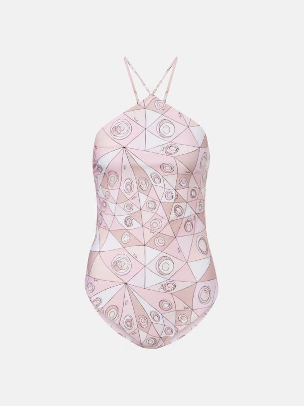 Pale pink and beige geometric printed one-piece swimsuit with a halter neckline and small ring hardware at the waist, displayed flat on a white background.