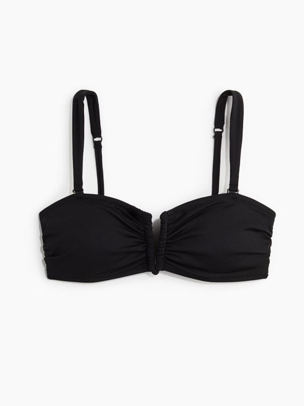 Black ruched-centre bandeau bikini top with thin adjustable straps, displayed flat on a white background.